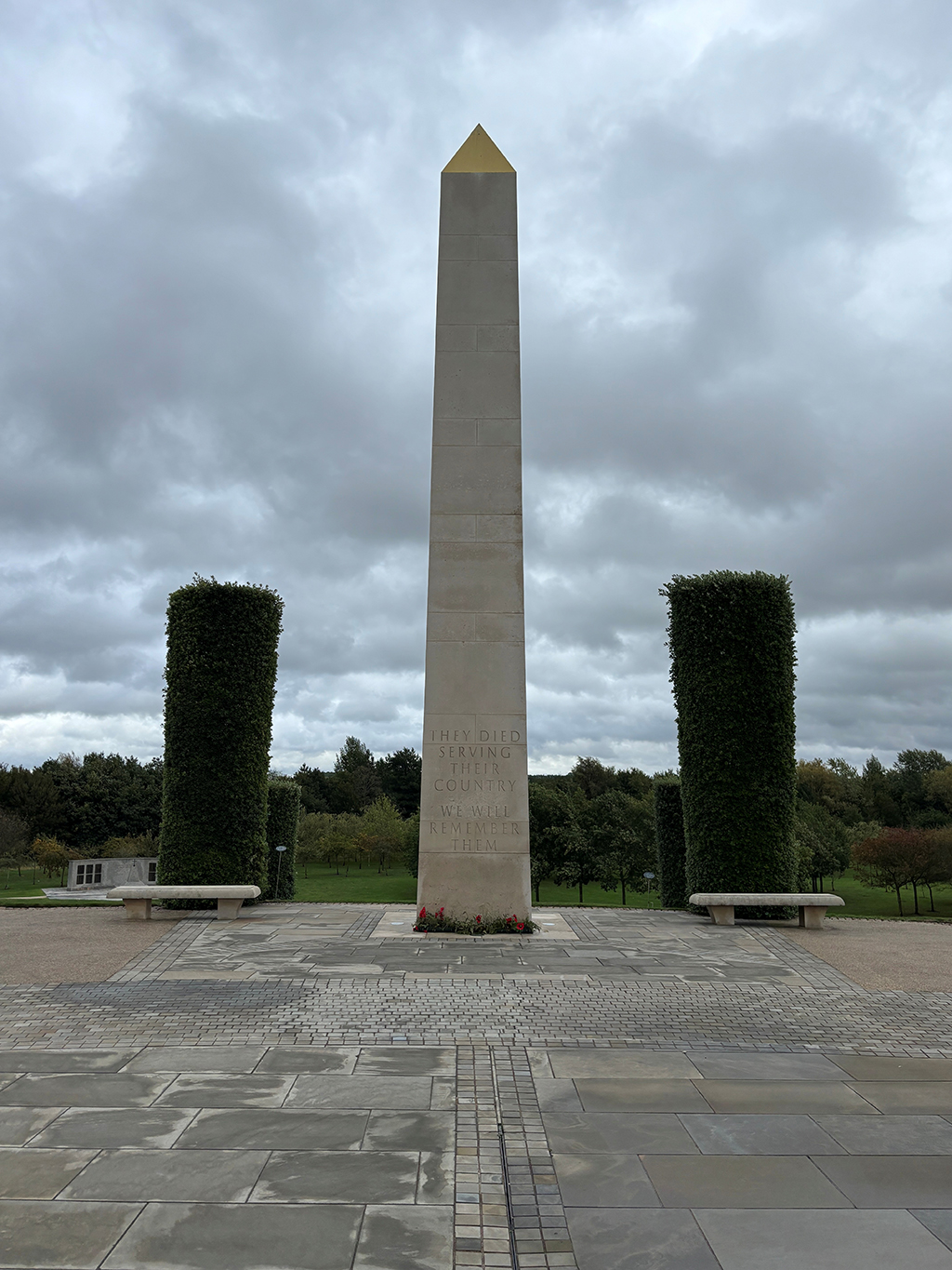 Memorial obelisk, engraved in capital letters, with the words, 'They died serving their country', and in the second paragraph, 'We will remember them'.